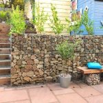 A gabion is a structure made of a metal frame (mesh) filled with stones or other material